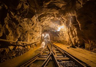 Underground gold mine tunnel with rails