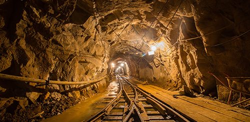 Underground gold mine tunnel with rails